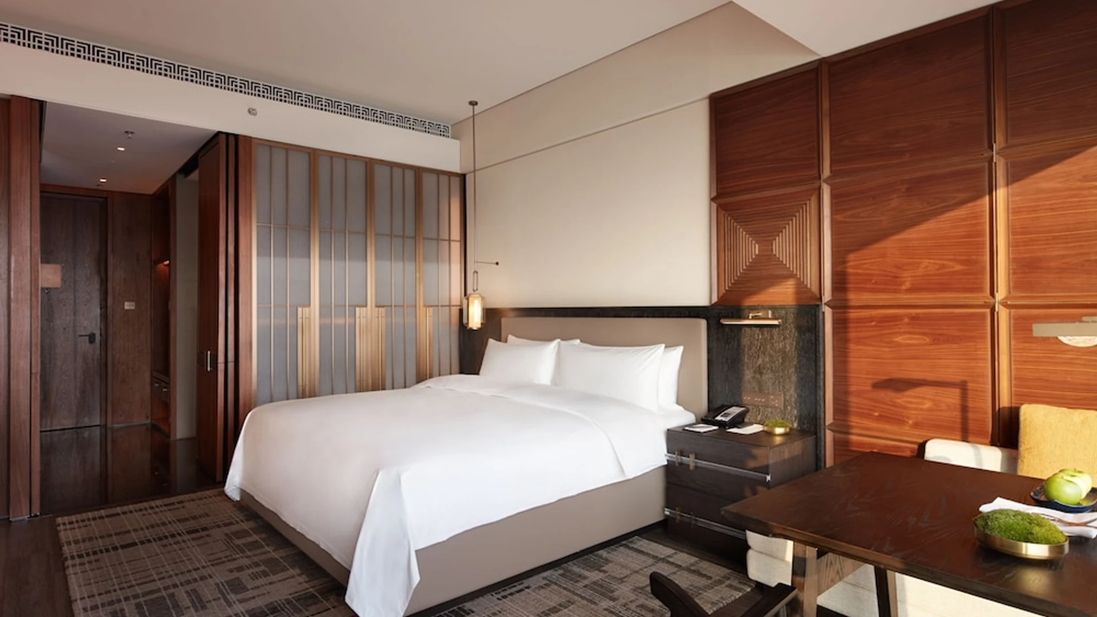 Warm wood-panelled guest room